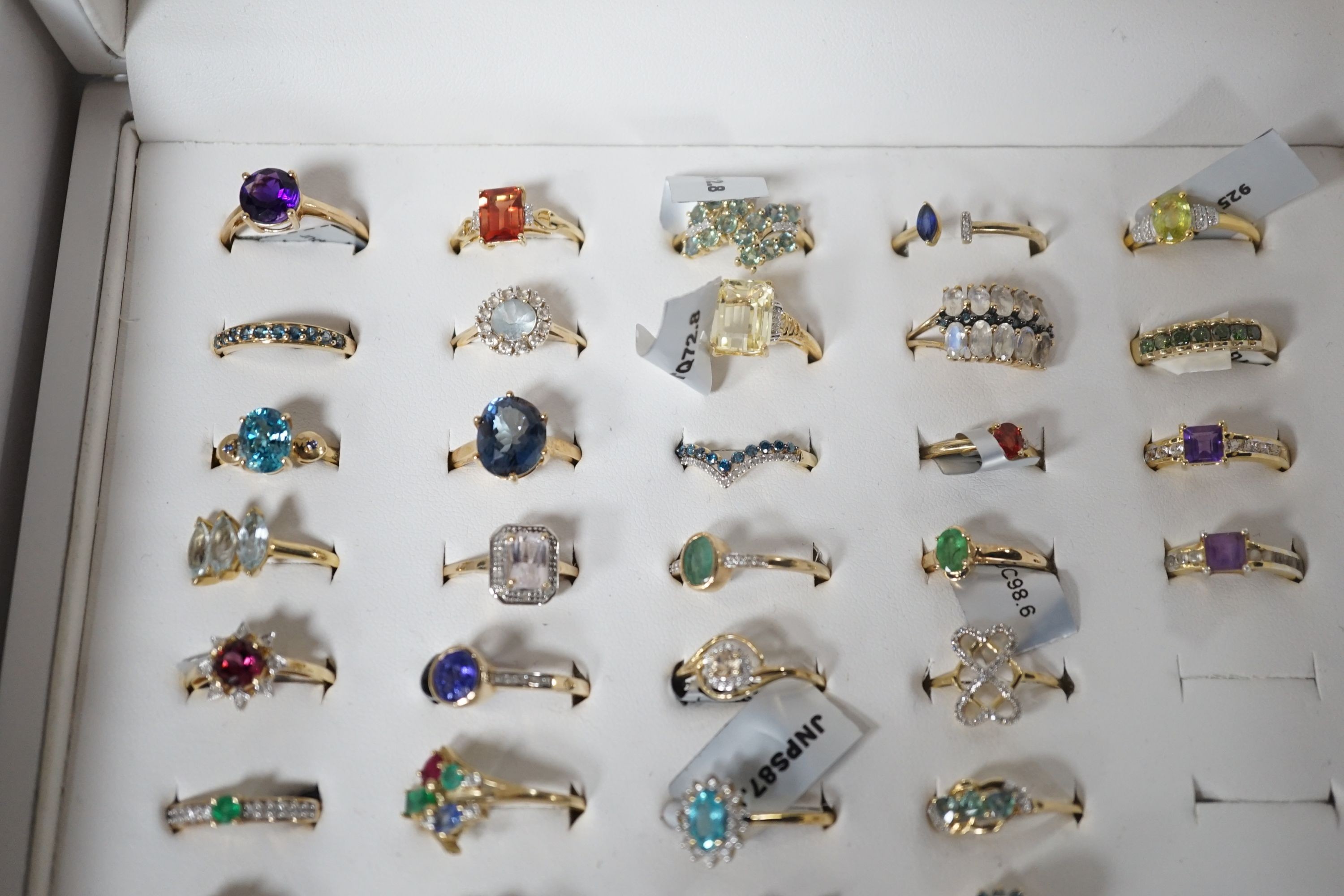 A collection of thirty nine assorted modern 9ct gold and gem set rings including amethyst, cultured pearl and emerald, three 18ct gold and gem set rings including two diamond clusters and an emerald and diamond cluster a